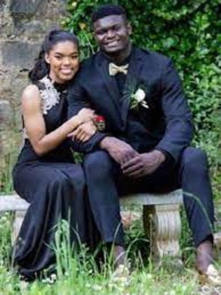 They both are wearing a black dress.